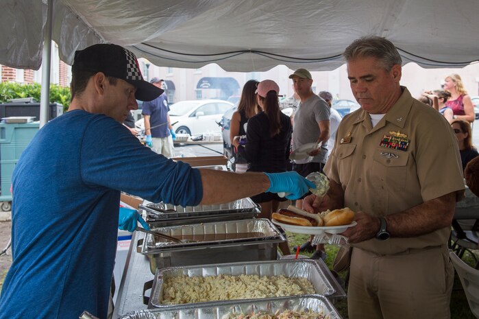 Capt. Timothy Sparks, Joint Base Charleston deputy commander, enjoys a birthday meal food during the Coast Guard birthday celebration Aug. 4, 2014, at U.S.C.G. Sector Charleston, S.C. The celebration included a cook-out, games and raffle prizes. (U.S. Air Force photo/Senior Airman George Goslin)
