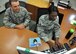 TSgt Sharina Warner, 647th Logistics Readiness Squadron commander support staff NCOIC, teaches Senior Airman Westin Hood, 940th LRS knowledge operations manager, different electronic management systems at Joint Base Pearl Harbor Hickam, Hawaii, July 21.  Using some of the different systems can increase office efficiency and streamline processes back at Hood's homestation, Beale Air Force Base, California. Hood, and other unit members are training with the 647th to refine their skills. (U.S. Air Force photo by Tech Sgt. Heather Skinkle/Released)
