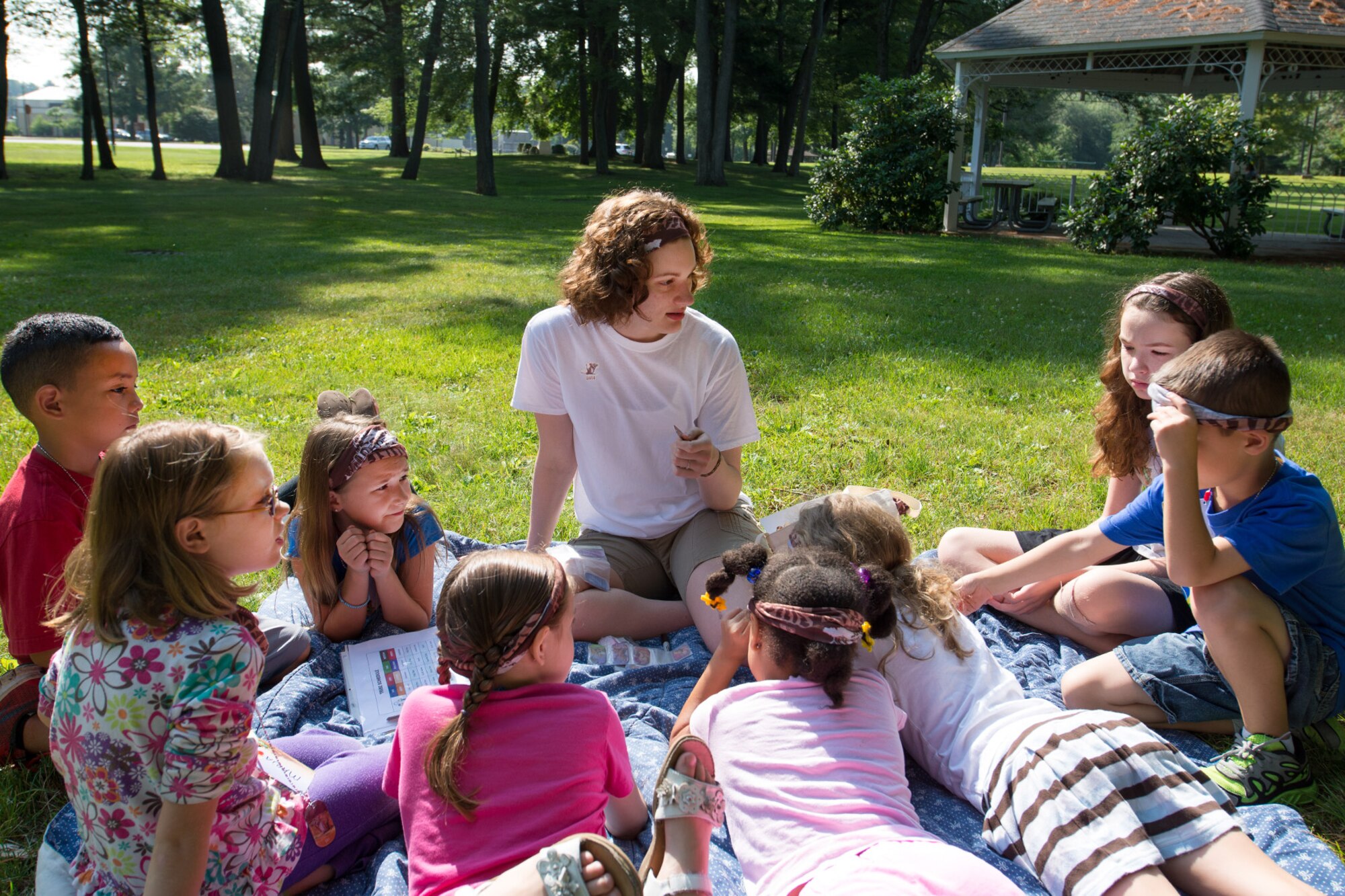 BEDFORD, Mass. – Emily Borger, a Vacation Bible School volunteer, leads children during a lesson at Vacation Bible School outside the Hanscom Chapel Aug. 5. The Chapel hosted the week-long event that integrates Bible lessons with fun activities for children in kindergarten through sixth grade. (U.S. Air Force photo by Rick Berry)