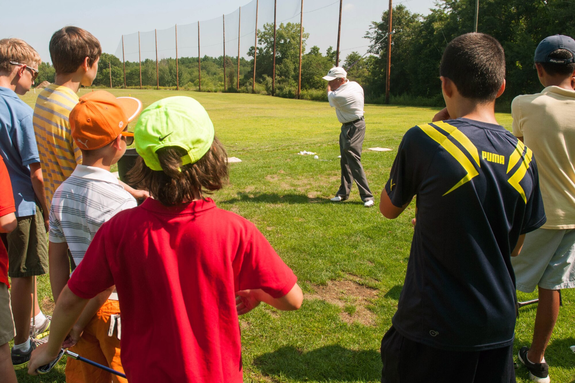 BEDFORD, Mass. -- Jim Tobin, a golf instructor at the Patriot Golf Course, demonstrates proper swing technique during the Golf 4 Kids summer camp at the base golf course Aug 5. Kids participating in the camp receive a solid foundation in golf, which includes swing mechanics, etiquette, terminology and how to maintain the speed of play. (U.S. Air Force Photo by Mark Herlihy)