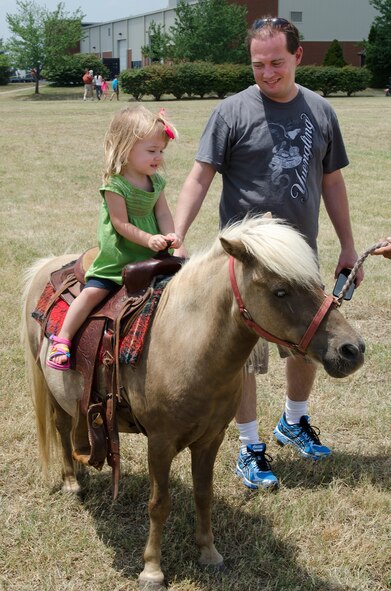 More than 500 family members and retirees attended The 123rd Airlift Wing’s annual Family Day at the Kentucky Air National Guard Base in Louisville, Ky., on July 13, 2014. This year’s event was the largest ever hosted by the wing and featured such activities as a tug-of-war tournament, petting zoo and pony rides. (U.S. Air National Guard photo by Senior Airman Joshua Horton)