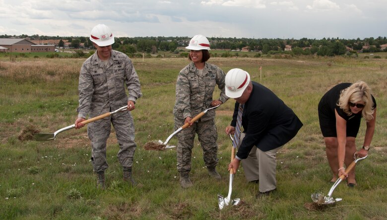 From left, Col. John Wagner, 460th Space Wing commander; Col. Rose Jourdan, 460th Mission Support Group commander; Al Woolley, 460th Force Support Squadron director; and Cindy Stark, 460th Force Support Squadron family member programs chief, break ground for a new accessible community park near the chapel Aug. 5, 2014, at the chapel on Buckley Air Force Base, Colo. The groundbreaking ceremony also included mention of a new accessible playground set to replace a current playground area. The projects, which are estimated to cost approximately $500,000, are scheduled to be complete in September.  (U.S. Air Force photo by Tech. Sgt. Kali L. Gradishar/Released)