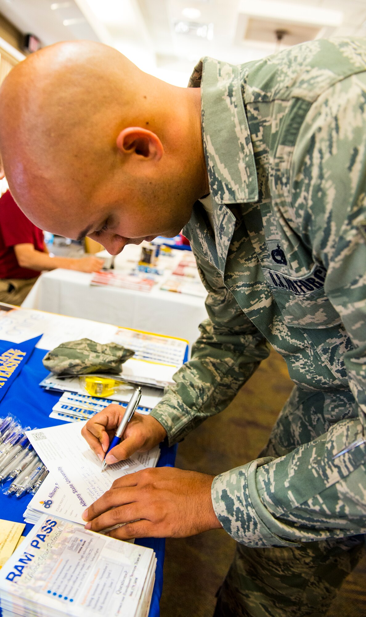 U.S. Air Force Staff Sgt. Matthew Eppard, 23d Aircraft Maintenance Squadron weapons technician, fills out a contact card during the annual Education Fair at Moody Air Force Base, Ga., Aug. 6, 2014. Colleges use this card to identify individuals who are interested in their school and give them information regarding the degree program they choose. (U.S. Air Force photo by Airman  1st Class Ceaira Tinsley/Released)