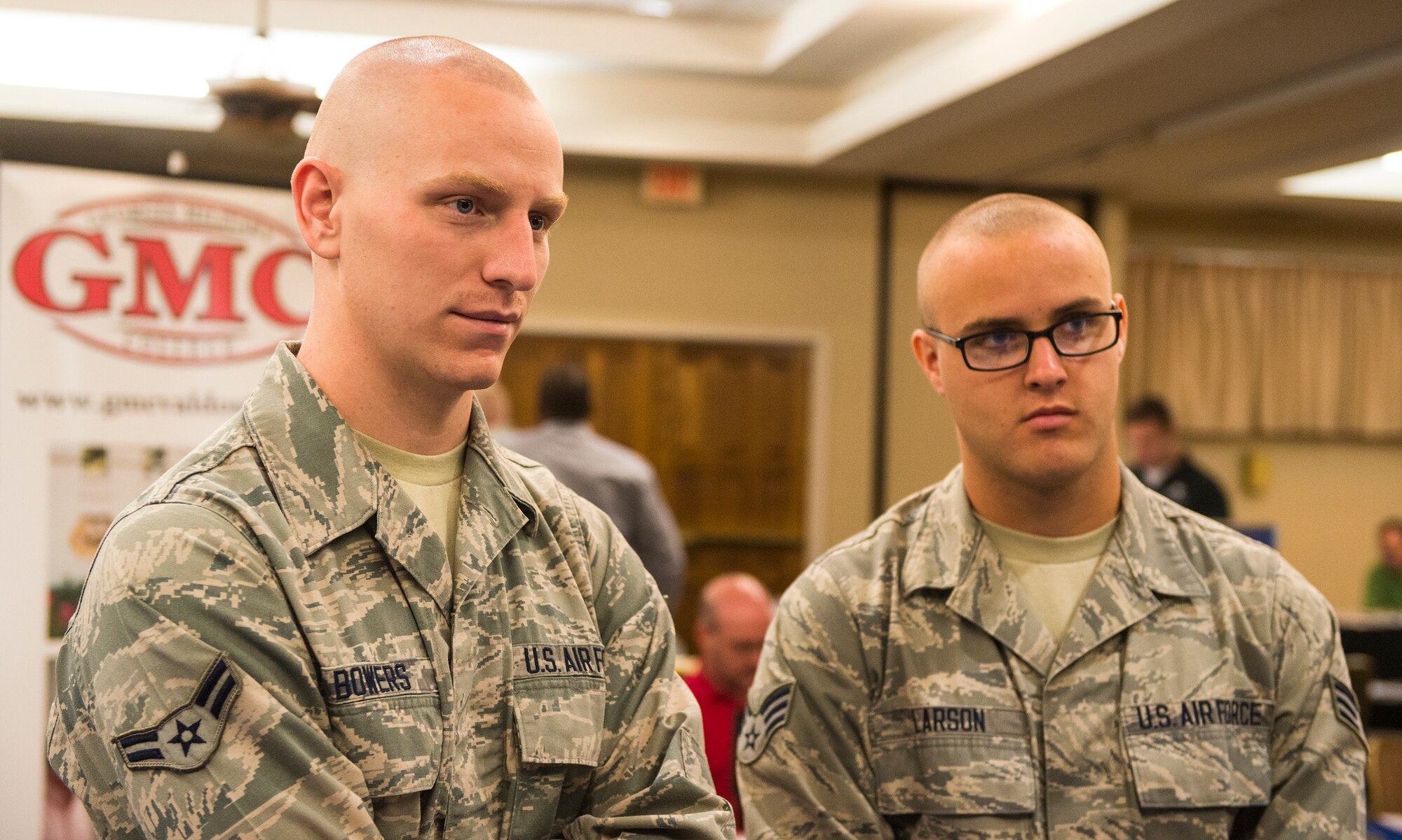 U.S. Air Force Airman 1st Class Steven Bowers, left, 23d Equipment Maintenance Squadron inspection section apprentice, and Senior Airman Jesse Larson, 723d Aircraft Maintenance Squadron airlift special mission aircraft maintenance journeyman, listen to an admissions counselor during the annual Education Fair at Moody Air Force Base, Ga., Aug. 6, 2014. The counselor described how different degrees can help diversify a resume’. (U.S. Air Force photo by Airman 1st Class Ceaira Tinsley/Released)