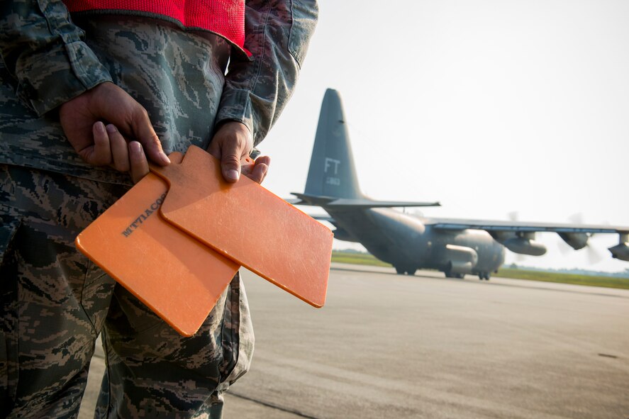 U.S. Air Force Senior Airman Chad Mitchell, 723d Aircraft Maintenance Squadron assistant dedicated crew chief, stands by as HC-130P Combat King, tail number 64-4863, taxis to the flightline at Moody Air Force Base, Ga., Aug. 6, 2014. A 71st Rescue Squadron air crew flew the retiring C-130 to Davis-Monthan Air Force Base, Ariz., where it’s planned to spend the rest of its days. (U.S. Air Force photo by Staff Sgt. Jamal D. Sutter/Released)   
