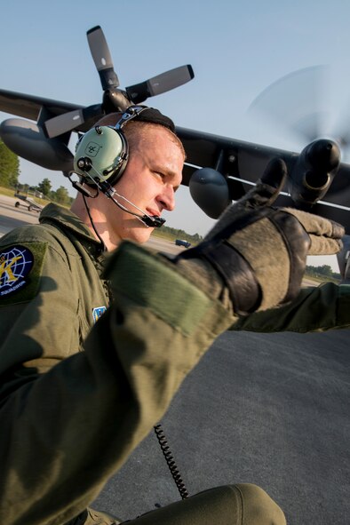 U.S. Air Force Airman 1st Class Todd Truran, 71st Rescue Squadron loadmaster, signals to a crew member as he checks rotor blades for HC-130P Combat King, tail number 64-4863, Aug. 6, 2014, at Moody Air Force Base, Ga. Truran and five other Airmen flew the retiring aircraft to Davis-Monthan Air Force Base, Ariz., to see it to its final resting place. (U.S. Air Force photo by Staff Sgt. Jamal D. Sutter/Released)