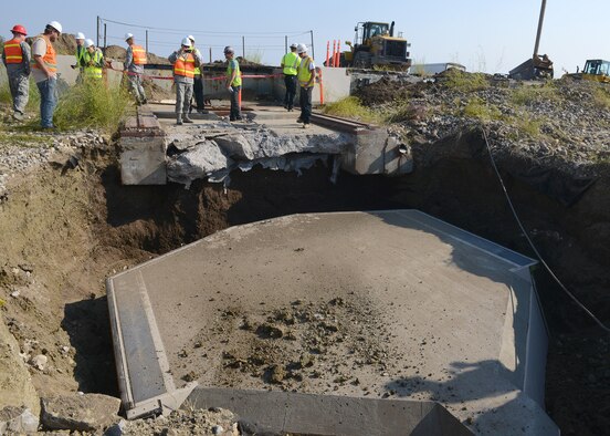 Col. Tom Wilcox, 341st Missile Wing commander, photographs Launch Facility T-49’s dismantled launcher closure door Aug. 5, 2014. The site is the last of 50 Minuteman III missile launch silos once operated by the 564th Missile Squadron that are being eliminated from Malmstrom Air Force Base, Mont., in compliance with the New Strategic Arms Reduction Treaty. (Air Force photo/Senior Airman Katrina Heikkinen)