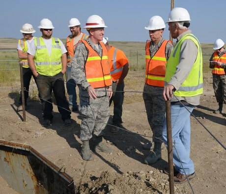 Lt. Gen. Stephen Wilson, Air Force Global Strike Command commander (center) reviews the demolition of Launch Facility T-49 with Col. Tom Wilcox, 341st Missile Wing commander, and Rick Bialczak, 341st MW treaty compliance office chief, Aug. 5, 2014. The site is the last of 50 Minuteman III missile launch silos once operated by the 564th Missile Squadron that are being eliminated from Malmstrom Air Force Base, Mont., in compliance with the New Strategic Arms Reduction Treaty. (Air Force photo/Senior Airman Katrina Heikkinen)