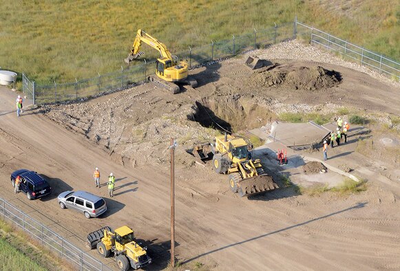 An aerial view of Launch Facility T-49 shows demolition of the launcher in progress Aug. 5, 2014. The site is located approximately 25 miles west of Conrad, Mont., and is the final deactivated Minuteman III missile launch silo of 50 once operated by the 564th Missile Squadron being eliminated from Malmstrom Air Force Base in accordance with the New Strategic Arms Reduction Treaty. (Air Force photo/Senior Airman Katrina Heikkinen)