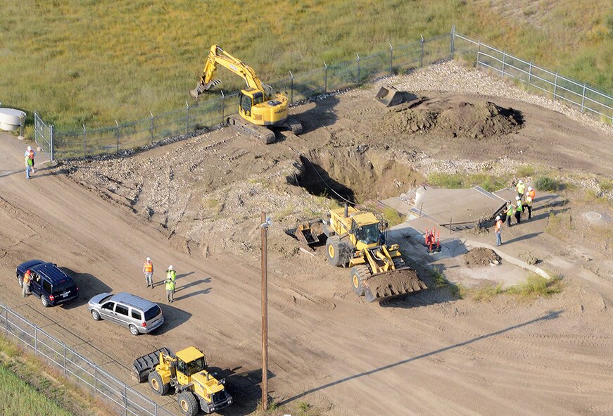 An aerial view of Launch Facility T-49 shows demolition of the launcher in progress Aug. 5, 2014. The site is located approximately 25 miles west of Conrad, Mont., and is the final deactivated Minuteman III missile launch silo of 50 once operated by the 564th Missile Squadron being eliminated from Malmstrom Air Force Base in accordance with the New Strategic Arms Reduction Treaty. (Air Force photo/Senior Airman Katrina Heikkinen)