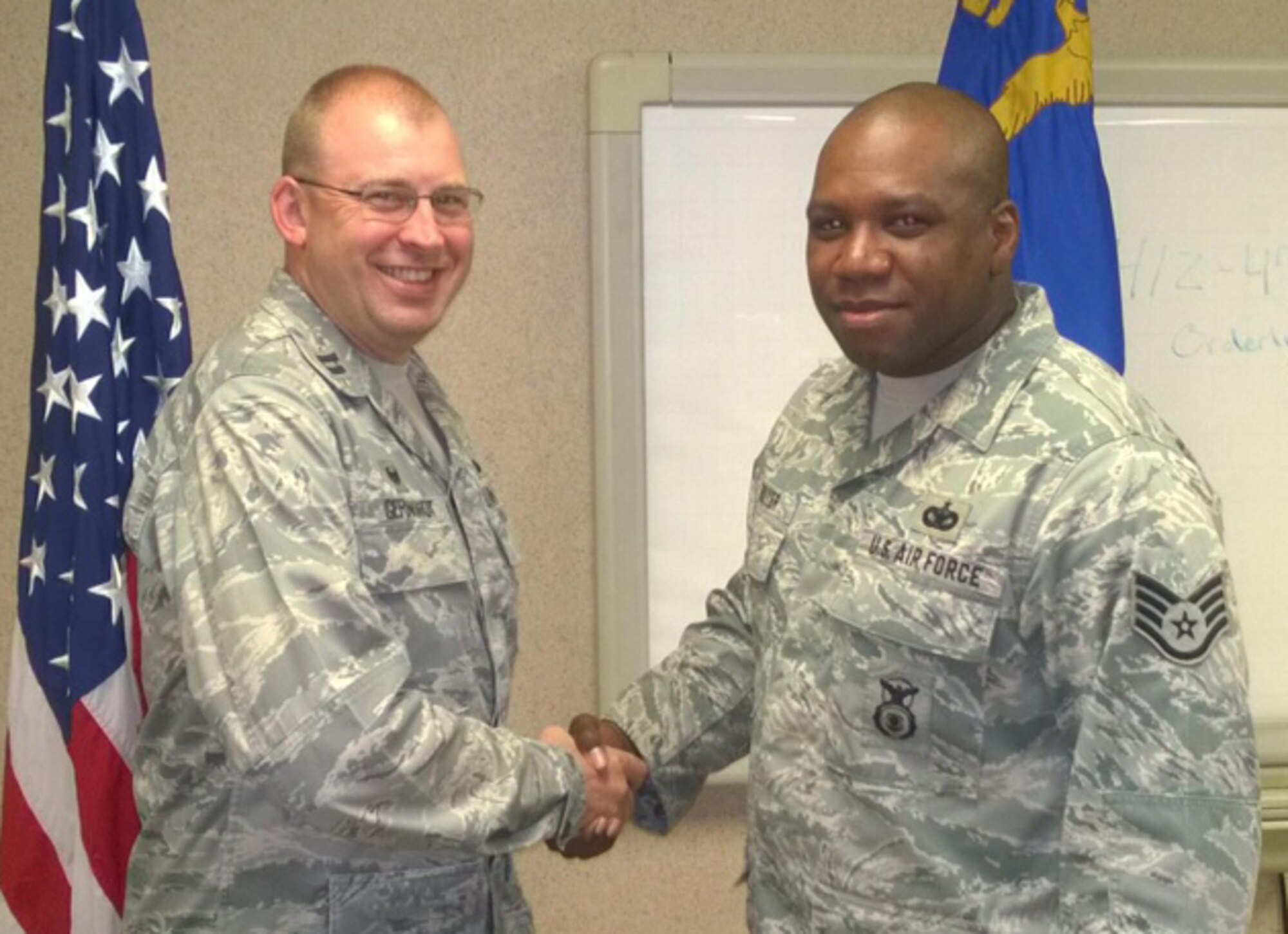 Staff Sgt. Raymond Bouyer of the 911th Security Forces Squadron was “coined” by Capt. Randall Gernhardt, 911th SFS Commander, June 7, 2014, in recognition of his recent life-saving actions. (courtesy photo)