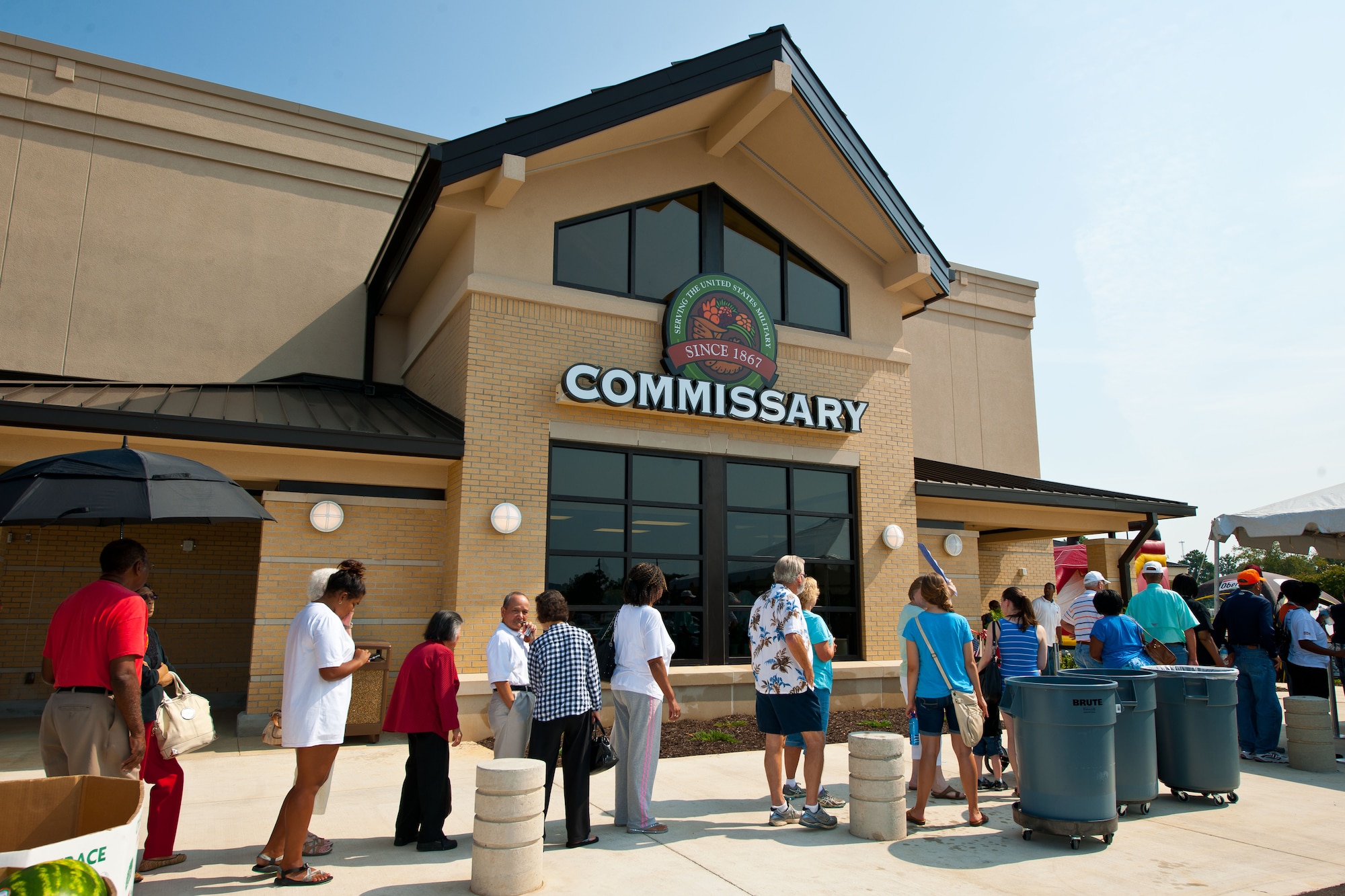 Patrons of the new Gunter-Annex commissary line-up to shop at the store’s grand opening Aug. 5, 2014. The commissary was approximately a year in the making and boasts a larger more energy efficient store than the previous commissary. At the grand opening people enjoyed free samples as well as giveaways including a $25 gift card for some. (U.S. Air Force photo by Donna L. Burnett) 