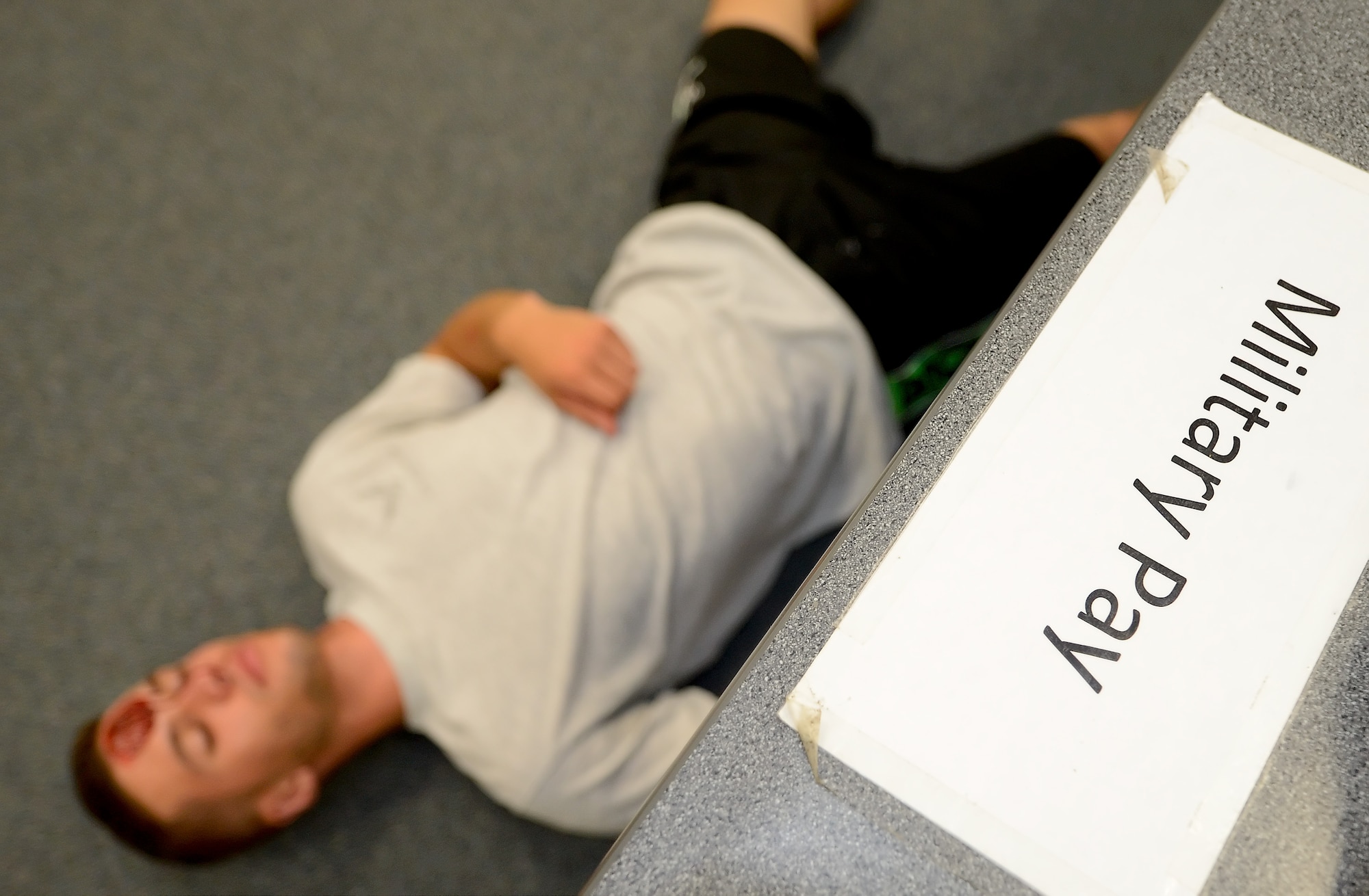 A label applied to a counter shows that Airman 1st Class Cameron Prescott, a 9th Airlift Squadron C-5M loadmaster, fell where he stood during an active shooter exercise in the finance section of Building 520 on Aug. 1, 2014, at Dover Air Force Base, Del. The scenario involved a disgruntled member that had issues with their military pay. (U.S. Air Force photo/Greg L. Davis)
