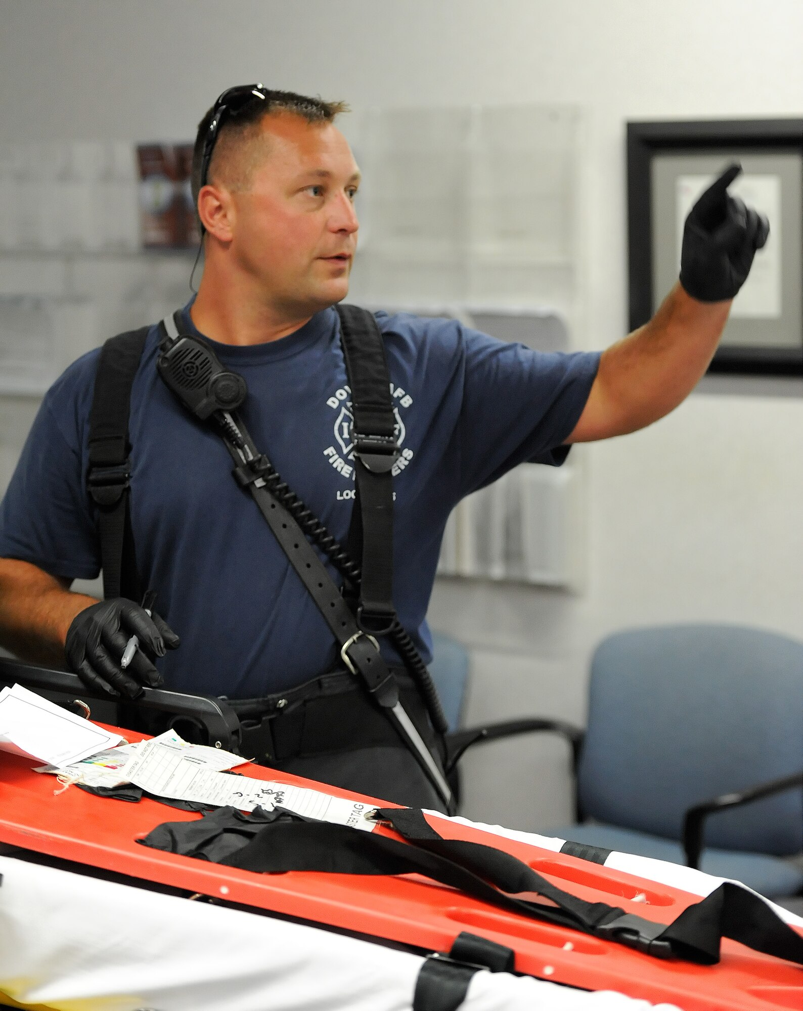Peter Bortz, 436th Civil Engineer Squadron, Fire Department, takes a count of casualties and the extent of their injuries in the aftermath an active shooter scenario Aug. 1, 2014, at Dover Air Force Base, Del. Bortz is a firefighter/emergency medical technician responsible for the quick evaluation and the orderly removal of casualties from the scene. (U.S. Air Force photo/Greg L. Davis)   