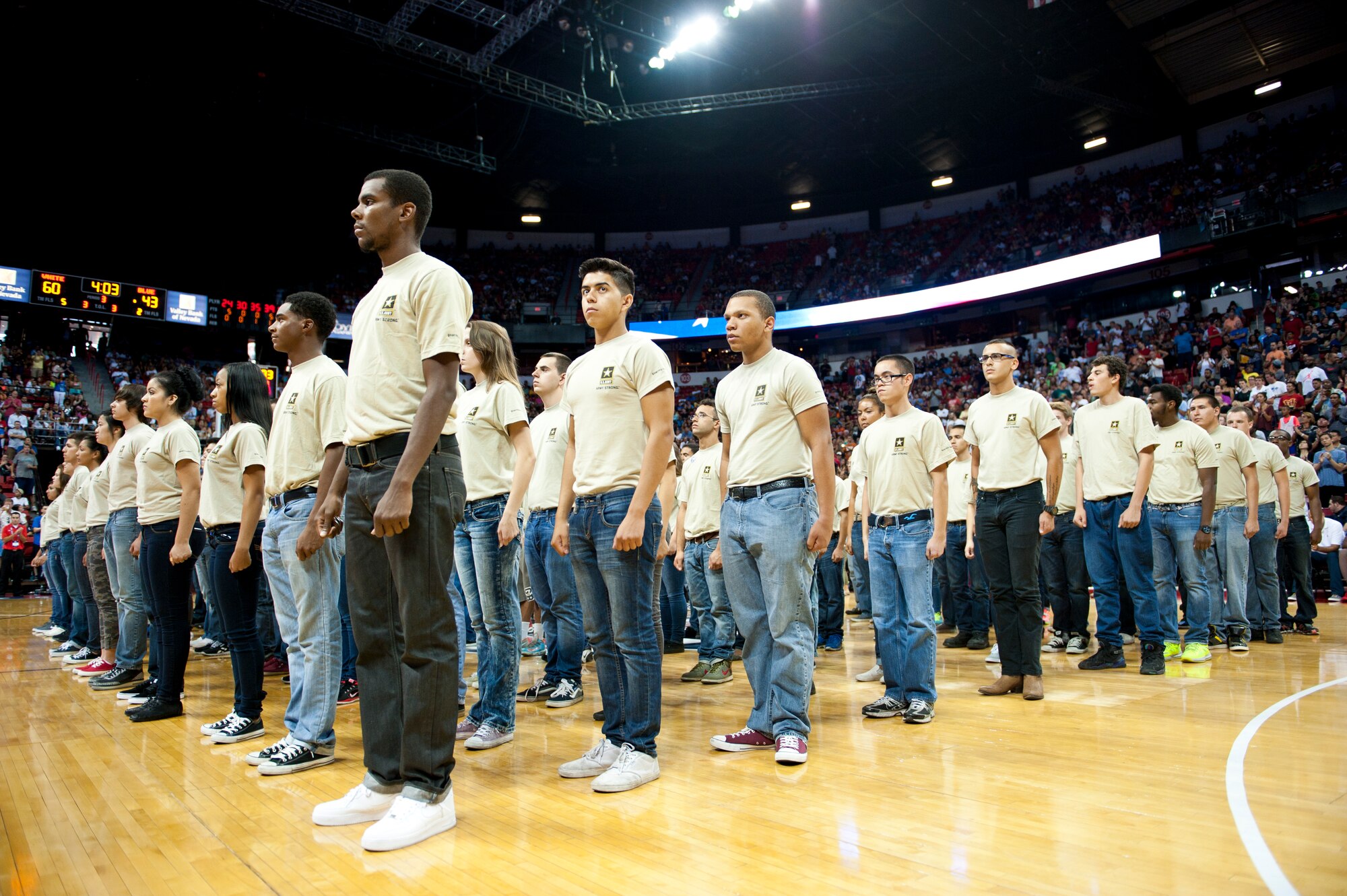 Individuals who were joining the U.S. Army wait on the court during halftime of a USA men’s national basketball team scrimmage at the Thomas and Mack Center in Las Vegas, August 1, 2014. These individuals were about the take the oath of enlistment. (U.S. Air Force photo by Airman 1st Class Thomas Spangler)