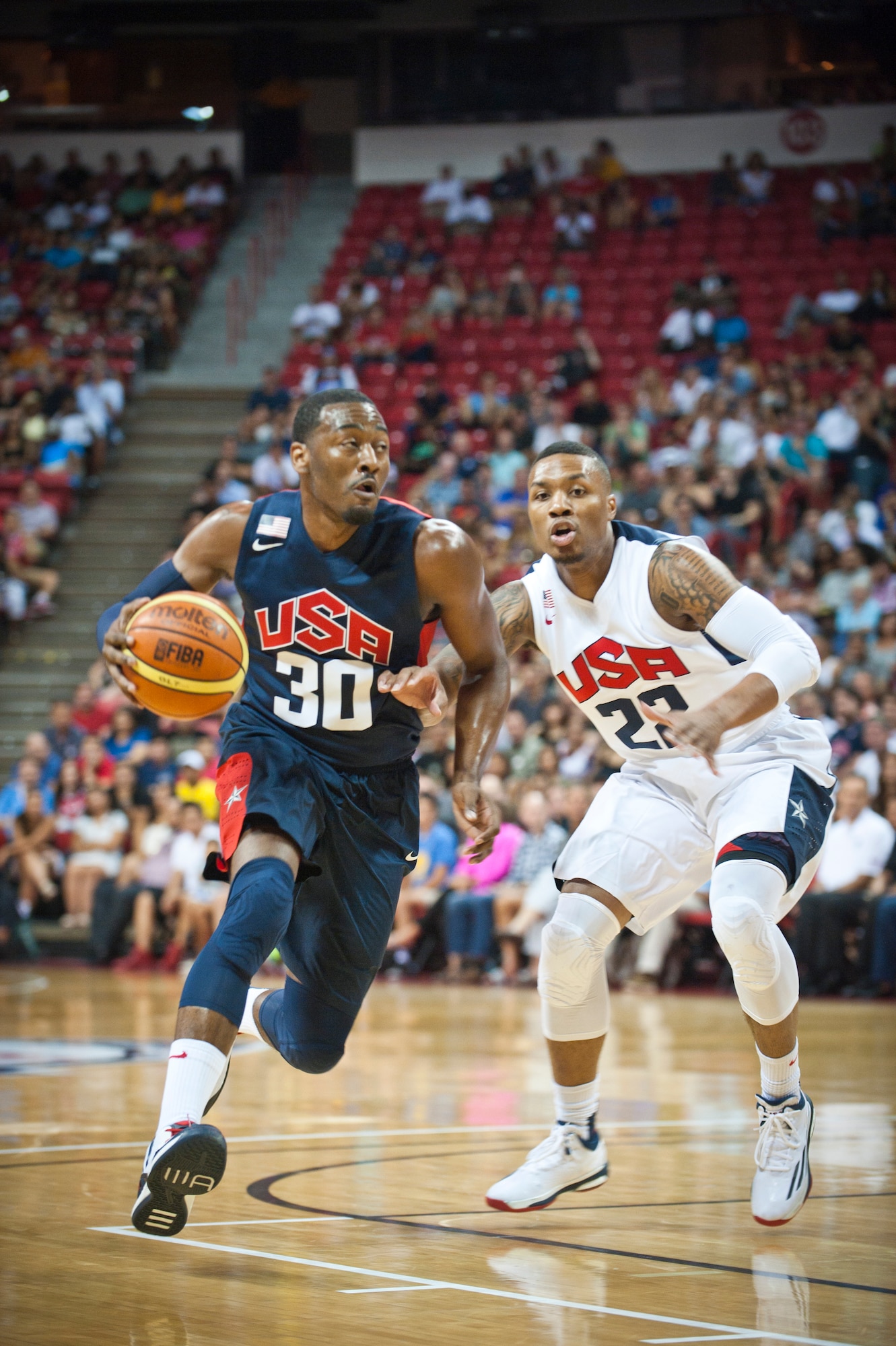 USA Basketball Men’s National Team guard John Wall (No. 30), drives past fellow guard and teammate Damian Lillard (No. 22), during an intra-squad scrimmage at the Thomas and Mack Center in Las Vegas, August 1, 2014. Wall and Lillard also play for the Washington Wizards and the Portland Trailblazers, respectively, in the National Basketball Association. (U.S. Air Force photo by Airman 1st Class Thomas Spangler) 