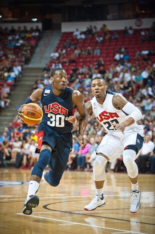 USA Basketball Men’s National Team guard John Wall (No. 30), drives past fellow guard and teammate Damian Lillard (No. 22), during an intra-squad scrimmage at the Thomas and Mack Center in Las Vegas, August 1, 2014. Wall and Lillard also play for the Washington Wizards and the Portland Trailblazers, respectively, in the National Basketball Association. (U.S. Air Force photo by Airman 1st Class Thomas Spangler) 