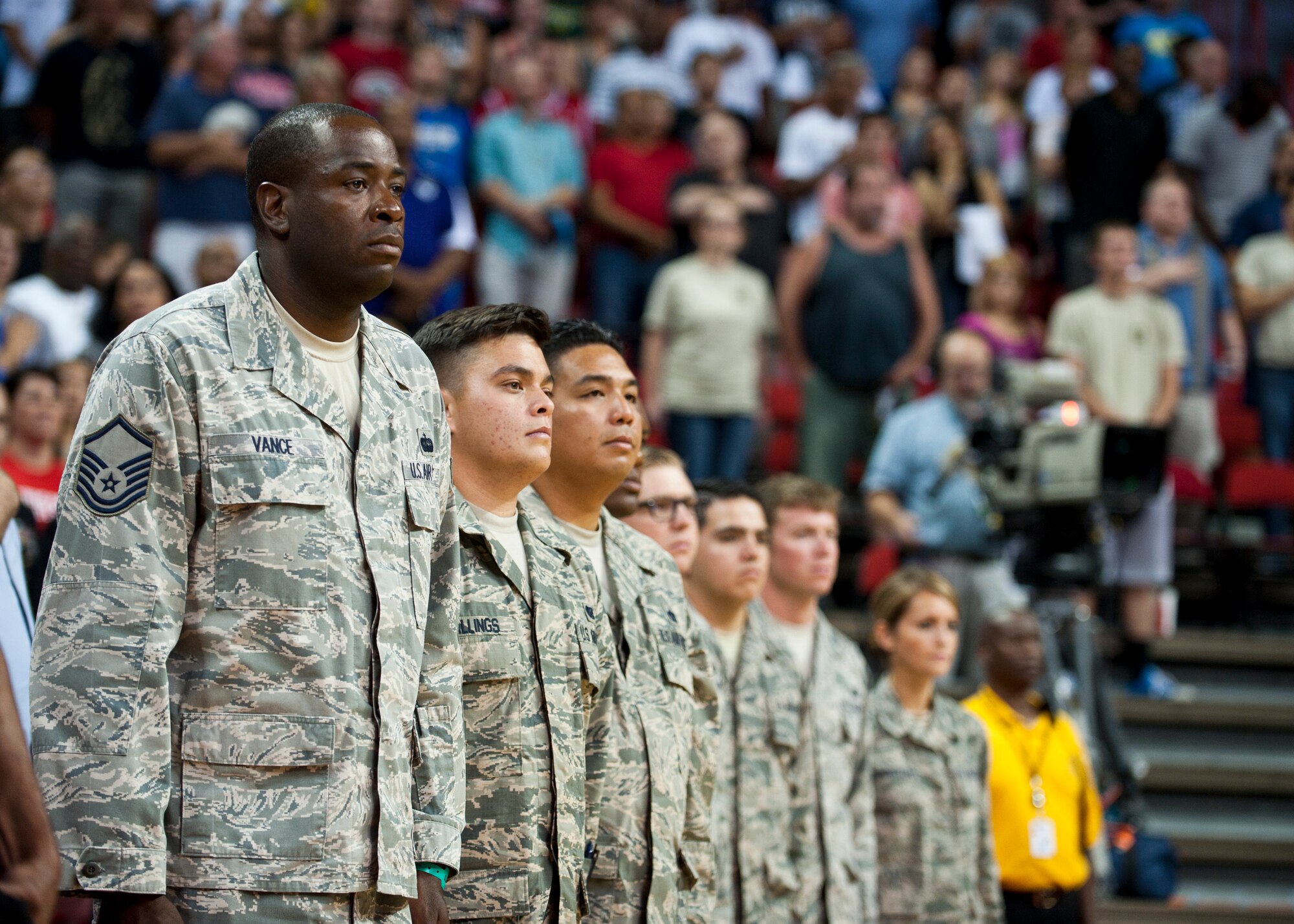 U.S. Air Force Airmen from Nellis Air Force Base, Nev. stand at attention during the singing of the National Anthem before a USA Basketball Men’s National Team intra-squad scrimmage at the Thomas and Mack Center in Las Vegas, August 1, 2014. The Airmen recently returned from deployment and were honored during the scrimmage. (U.S. Air Force photo by Airman 1st Class Thomas Spangler)