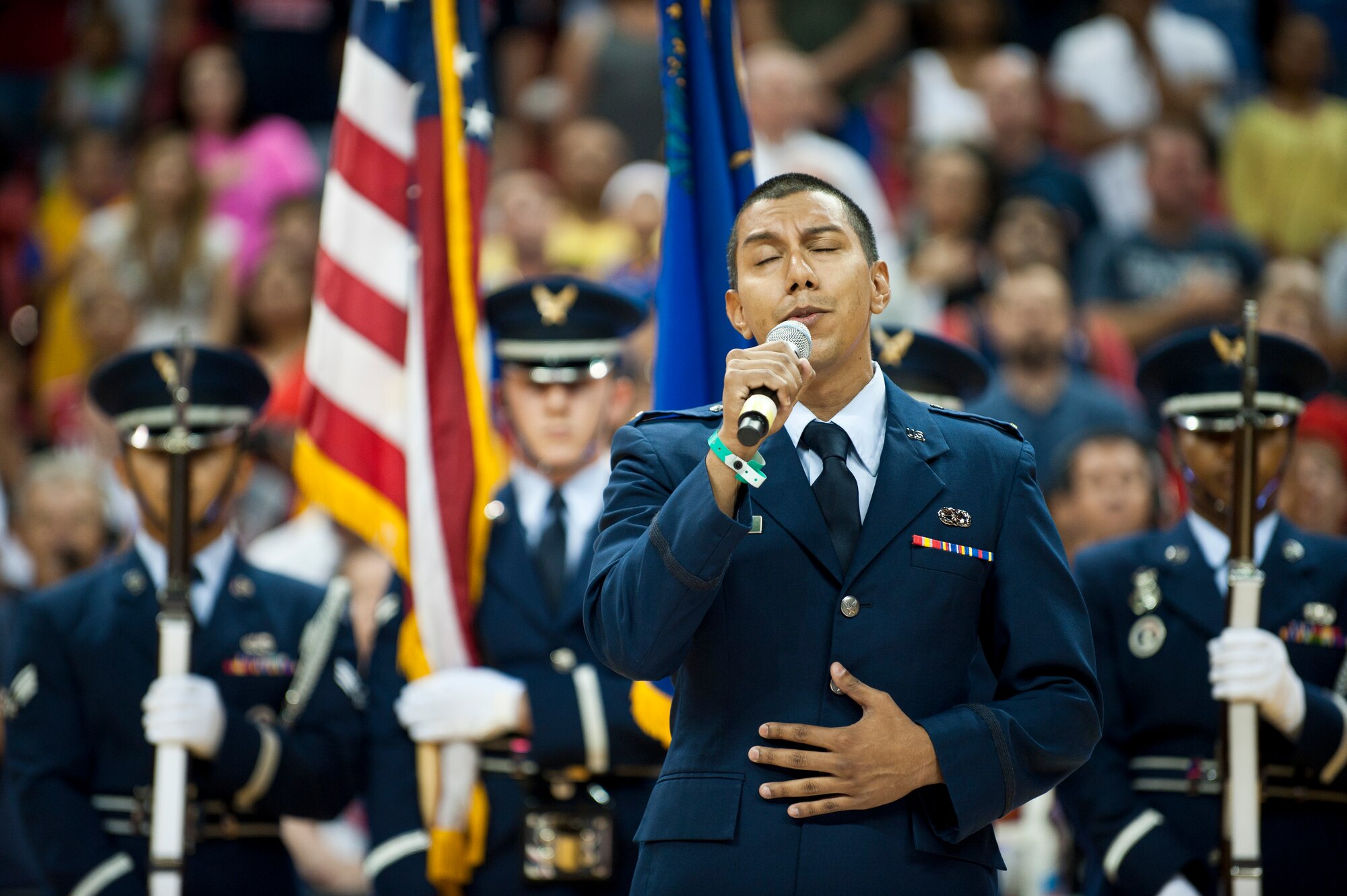 U.S. Air Force 2nd Lt. Daniel Vargas, 757th Aircraft Maintenance Squadron, Aircraft Maintenance Unit assistant officer in charge, sings the National Anthem at the Thomas and Mack Center in Las Vegas, August 1, 2014. Vargas preformed the National Anthem before a USA Basketball Men’s National Team intra-squad scrimmage. (U.S. Air Force photo by Airman 1st Class Thomas Spangler)