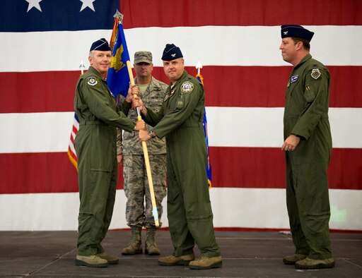 Maj. Gen. William Binger, 10th Air Force commander, (left) passes the 926th Group guidon to the new 926th GP commander, Col. Ross Anderson, during the change of command ceremony at Nellis Air Force Base, Nev., July 31, 2014. The 926th Group is comprised of 10 squadrons and one detachment located across the nation, is an Air Force Reserve unit assigned to the 10th AF. (U.S. Air Force photo by Airman 1st Class Mikaley Towle)