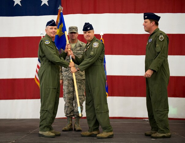 Maj. Gen. William Binger, 10th Air Force commander, (left) passes the 926th Group guidon to the new 926th GP commander, Col. Ross Anderson, during the change of command ceremony at Nellis Air Force Base, Nev., July 31, 2014. The 926th Group is comprised of 10 squadrons and one detachment located across the nation, is an Air Force Reserve unit assigned to the 10th AF. (U.S. Air Force photo by Airman 1st Class Mikaley Towle)