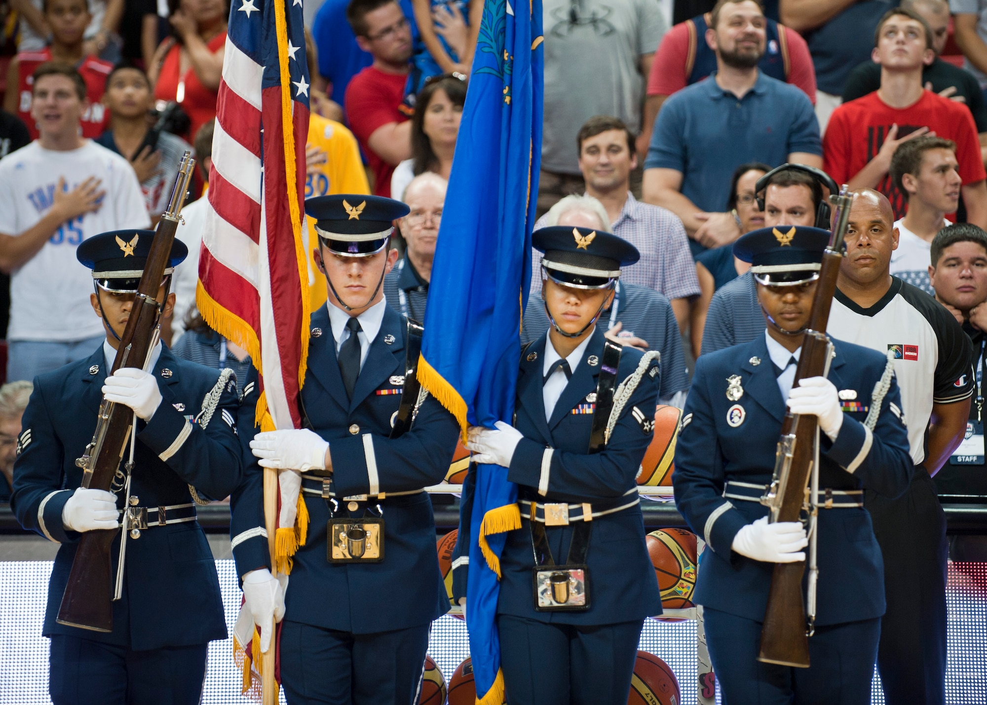The Nellis Air Force Base Honor Guard prepares to present the colors for the playing of the National Anthem before an intra-squad scrimmage of the USA Basketball Men’s National Team at the Thomas and Mack Center, August 1, 2014, Las Vegas. The Nellis Honor Guard preforms color guard more than 200 times a year. (U.S. Air Force photo by Airman 1st Class Thomas Spangler)
