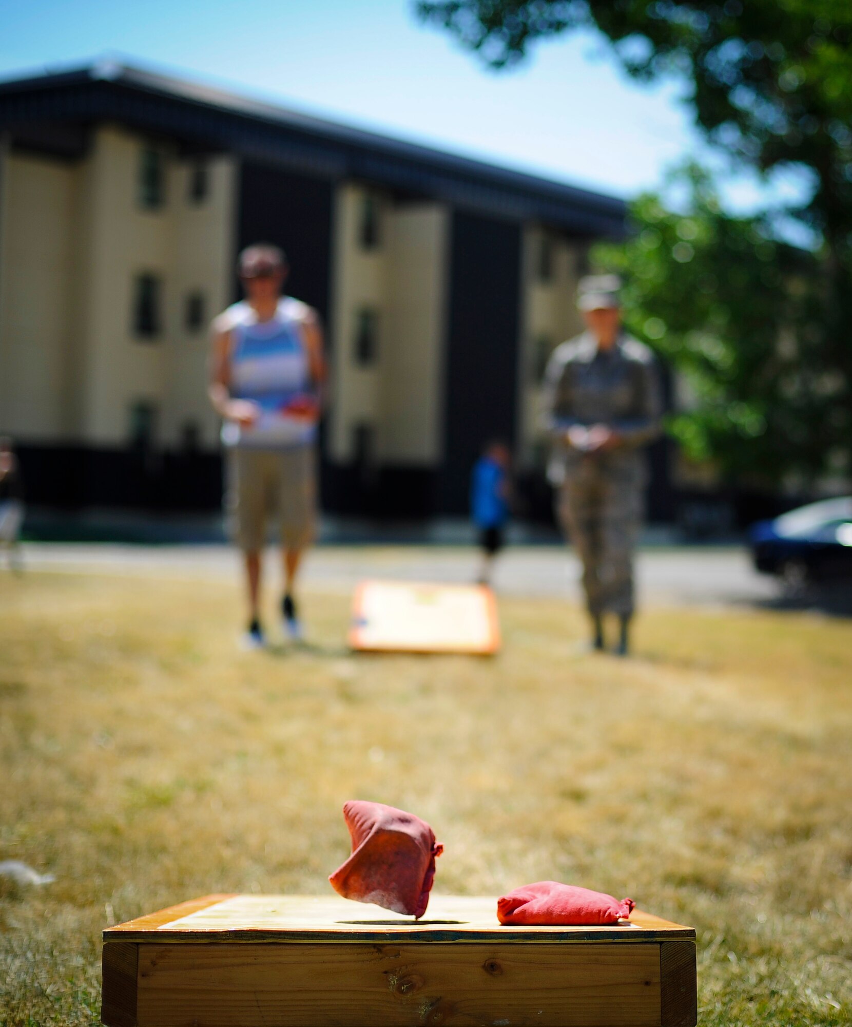 Team Malmstrom members play a game of cornhole during Malmstrom’s Fit Food Festival at Dorm 740’s pavilion Aug 1. In addition to complimentary food, Airmen had the opportunity to partake in more than five different activities and events throughout the course of the day. (U.S. Air Force photo/Airman 1st Class Collin Schmidt)