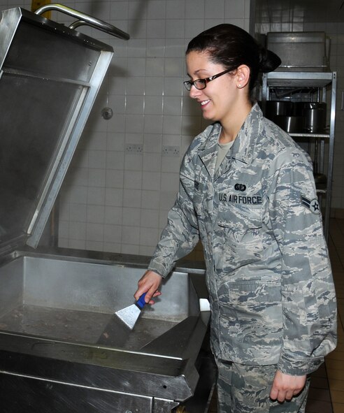 U.S. Air Force Airman 1st Class Meagan Rogers, 100th Force Support Squadron Services technician from Ridgeway, Va., prepares a stew dish July 31, 2014, on RAF Mildenhall, England. The Gateway Dining Facility is made up of 34 staff members, working to serve nutritious food to service members. (U.S. Air Force photo/Gina Randall/Released)
