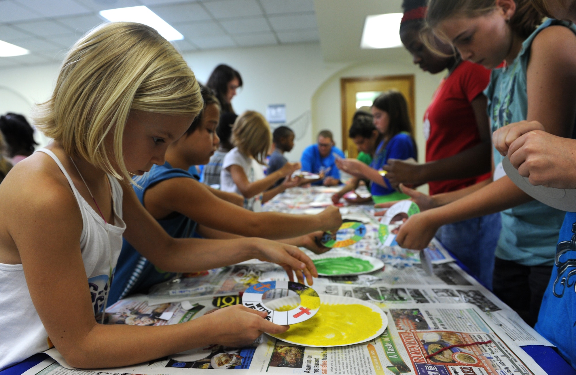 Kadena Vacation Bible school students participate in arts and crafts to help them better understand the teachings of the day, Aug. 6, 2014, at Chapel 3 on Kadena Air Base, Japan. The students spent the day playing games, making crafts, learning songs, and learning about Christianity Aug. 4-8.   Vacation Bible School helps Airmen and families by keeping them spiritually fit for the military lifestyle and helps boost the morale of military children. (U.S. Air Force photo by Airmen 1st Class Stephen G. Eigel/Released)