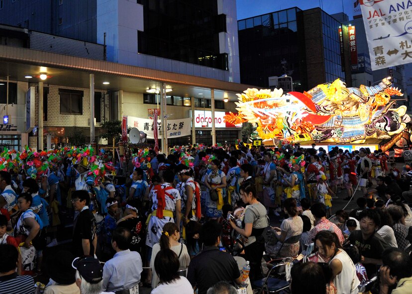 A procession consisting of thousands of Japanese participates in the annual Nebuta Matsuri in Aomori City, Japan, Aug 2. 2014. Parade participants wear the traditional red and white Haneto garb and bounce to the sound of beating Taiko drums and piercing flutes as they escort more than 30 floats down the city’s main street. (U.S. Air Force photo/Airman 1st Class Patrick S. Ciccarone)