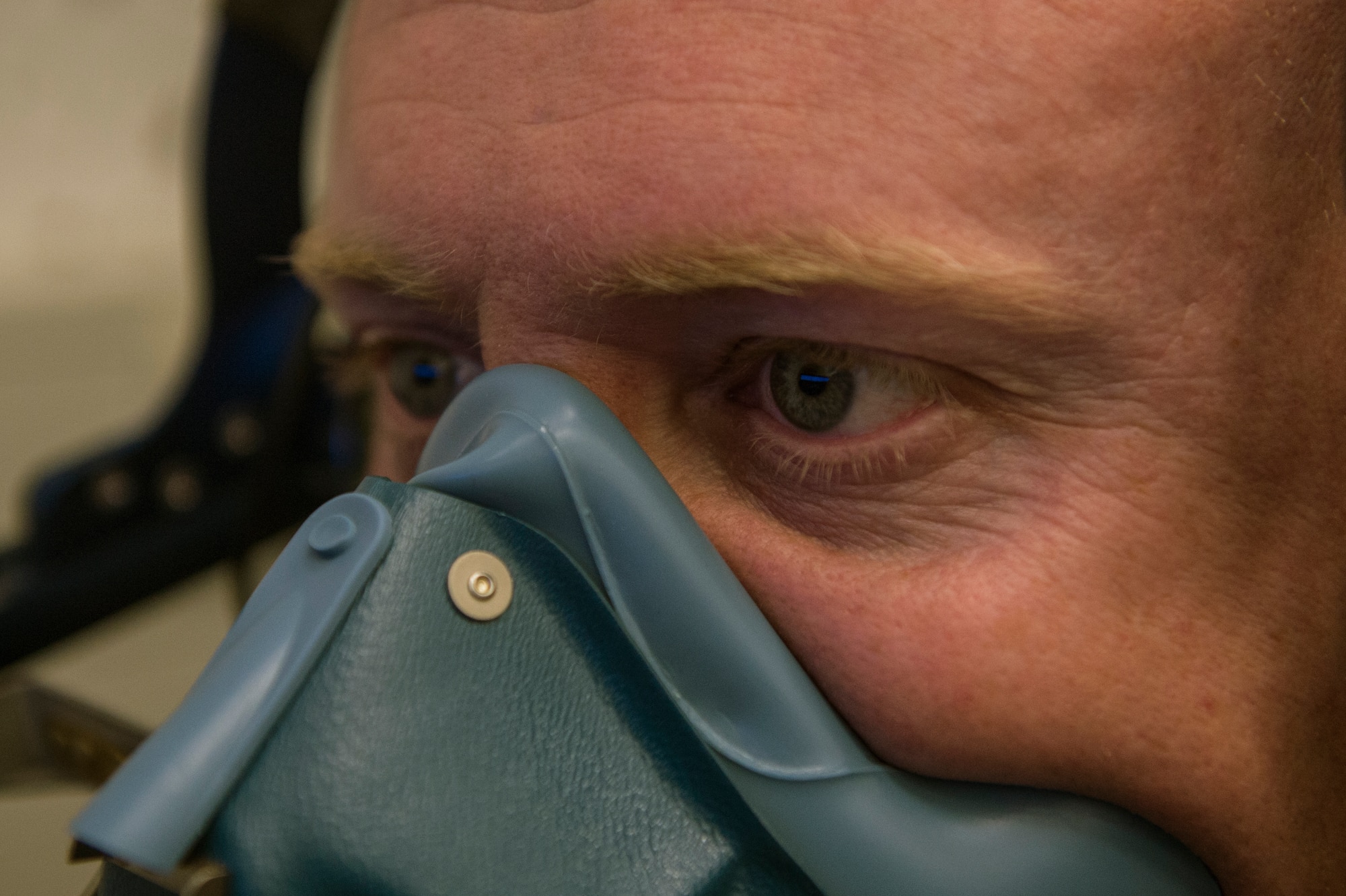 U.S. Air Force Tech. Sgt. Charles Myers, 52nd Operations Support Squadron NCO in charge of aerospace and operational physiology team from Frenchtown, N.M., wears a mask while operating a reduced oxygen breathing device July 28, 2014, at Spangdahlem Air Base, Germany. ROBD simulates an unpressurized cockpit of an aircraft so the operator can feel the effects of hypoxia and understand how to complete emergency procedures under those conditions. (U.S. Air Force photo by Senior Airman Rusty Frank/Released)