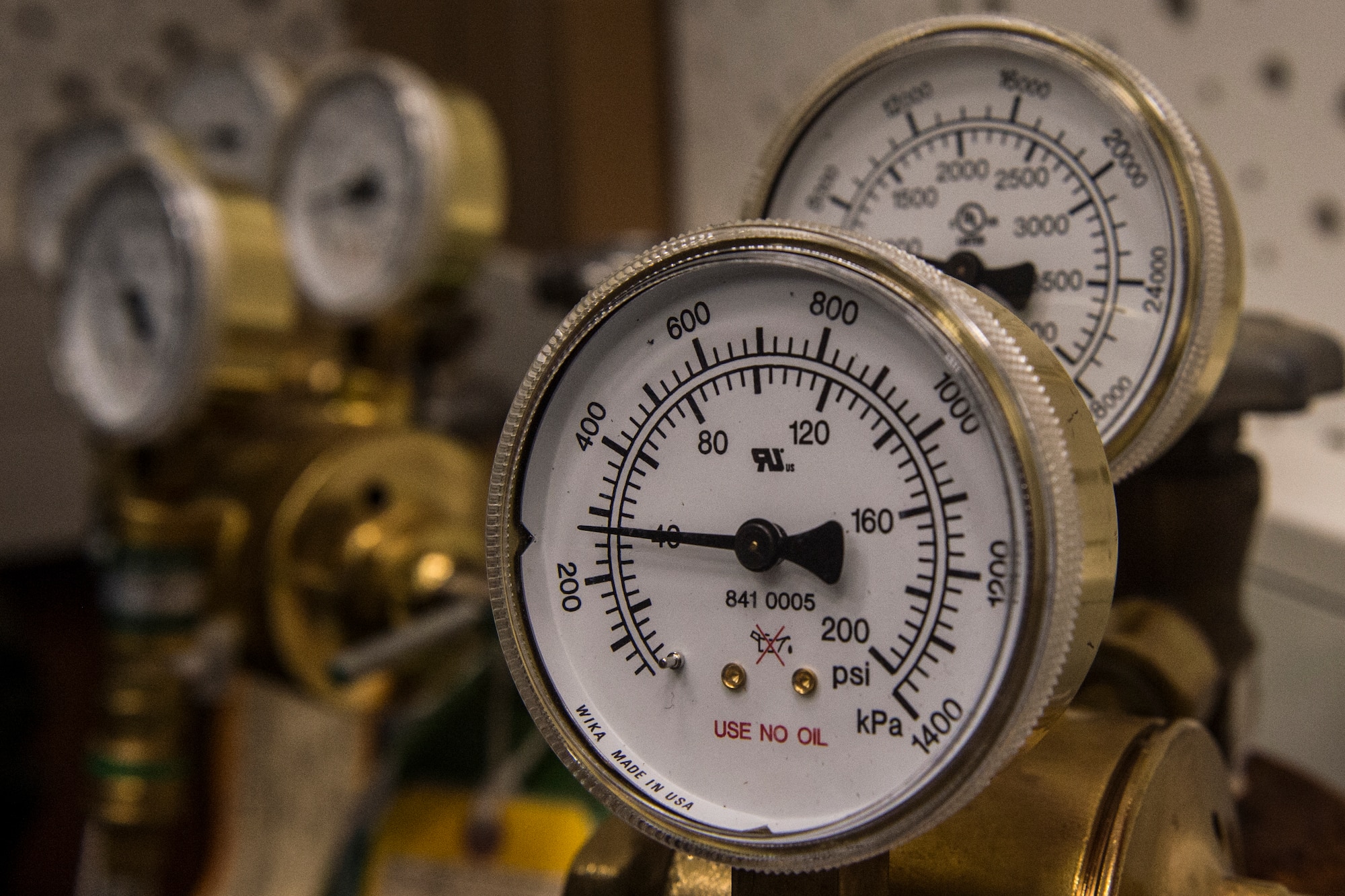 Oxygen tanks are displayed behind a reduced oxygen breathing device July 28, 2014, at Spangdahlem Air Base, Germany. The ROBD mixes oxygen and nitrogen to simulate an unpressurised cockpit of an aircraft so the pilots can feel some of the symptoms of hypoxia and learn to operate despite them. (U.S. Air Force photo by Senior Airman Rusty Frank/Released)