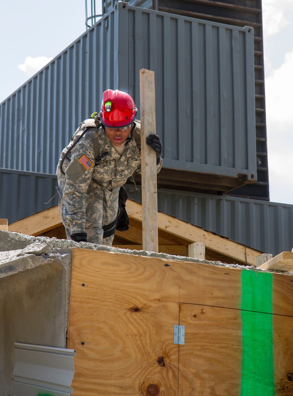 Army Pfc. Erica Haynes prepares to perform an extraction during the Vibrant Response 14 exercise at Camp Atterbury Joint Maneuver Training Center, Ind., Aug. 2, 2014. U.S. Army photo by Sgt. Dani Salvatore