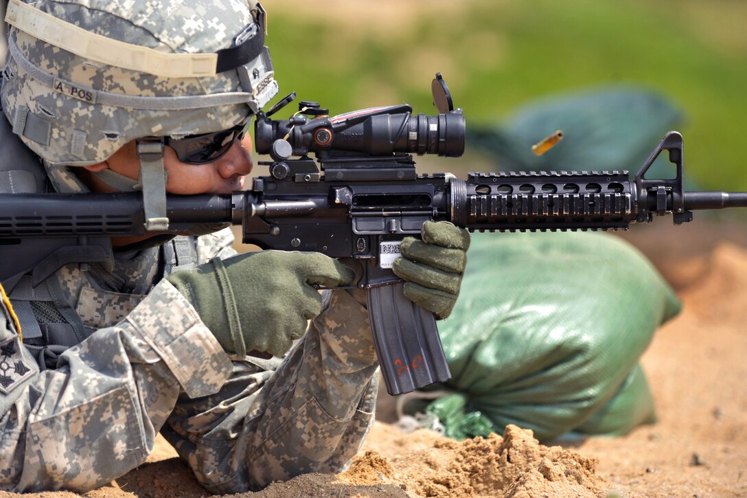 U.S. Army Sgt. 1st Class Jesse Jesse fires at a target during M4 carbine rifle qualification on Grafenwoehr Training Area, Germany, July 30, 2014. Jesse is assigned to Regimental Engineer Squadron, 2nd Cavalry Regiment.