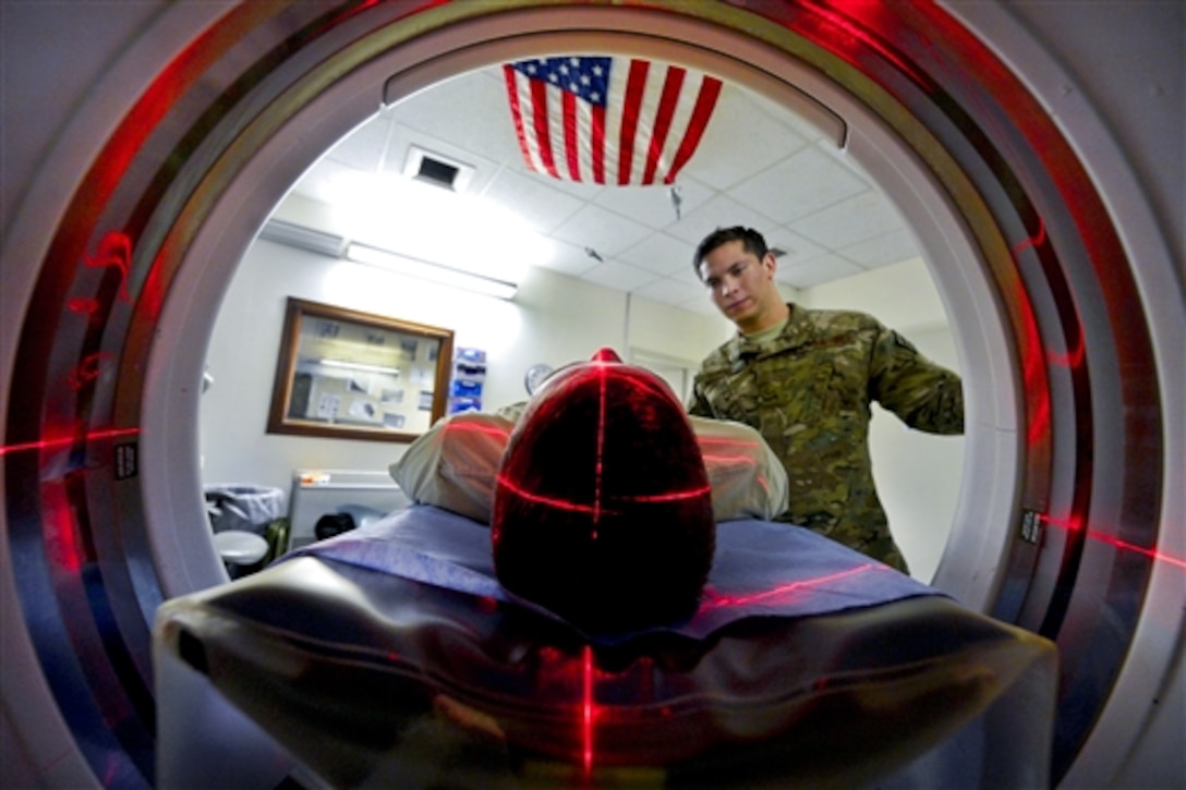 U.S. Air Force Senior Airman Freddy Toruno, right, positions a service member for a CT scan at the Craig Joint Theater Hospital on Bagram Airfield, Afghanistan, July 23, 2014. Toruno is a diagnostic imaging technologist assigned to the 455th Expeditionary Medical Group. 