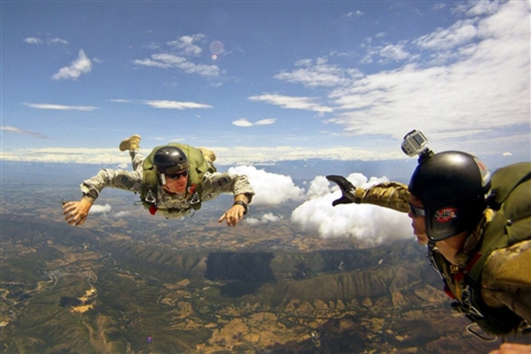 U.S. and Colombian paratroopers track during a free fall as part of Fuerzas Comando 2014 at the Colombian National Training Center on Fort Tolemaida, Colombia, July 30, 2014. The U.S. service members are assigned to Special Operations Command South. The jump symbolizes the strong partnership between both nations. 