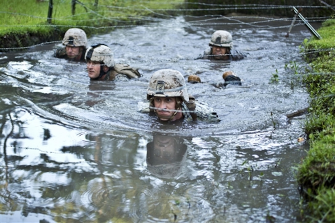 Marines execute the endurance course on Camp Lejeune, N.C., July 30, 2014. The endurance course is a 3.4-mile path through the woods that winds through swamps, creeks and obstacles to test endurance and ability to work as a team. The Marines are assigned to Golf Company, 2nd Battalion, 2nd Marine Regiment. 