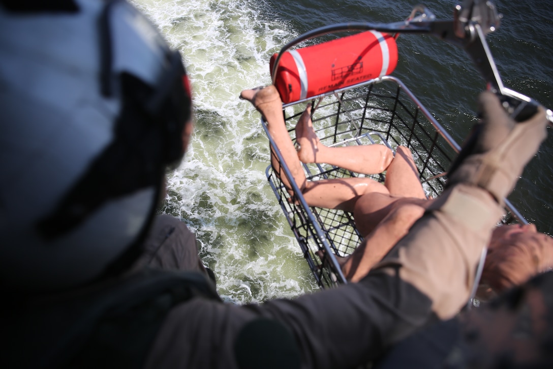 Cpl. Tyler McNair hoists a simulated victim out of the water during a casualty evacuation drill outside of Marine Corps Air Station Cherry Point, N.C., July 30, 2014. McNair is a crew chief with Marine Transport Squadron 1. 