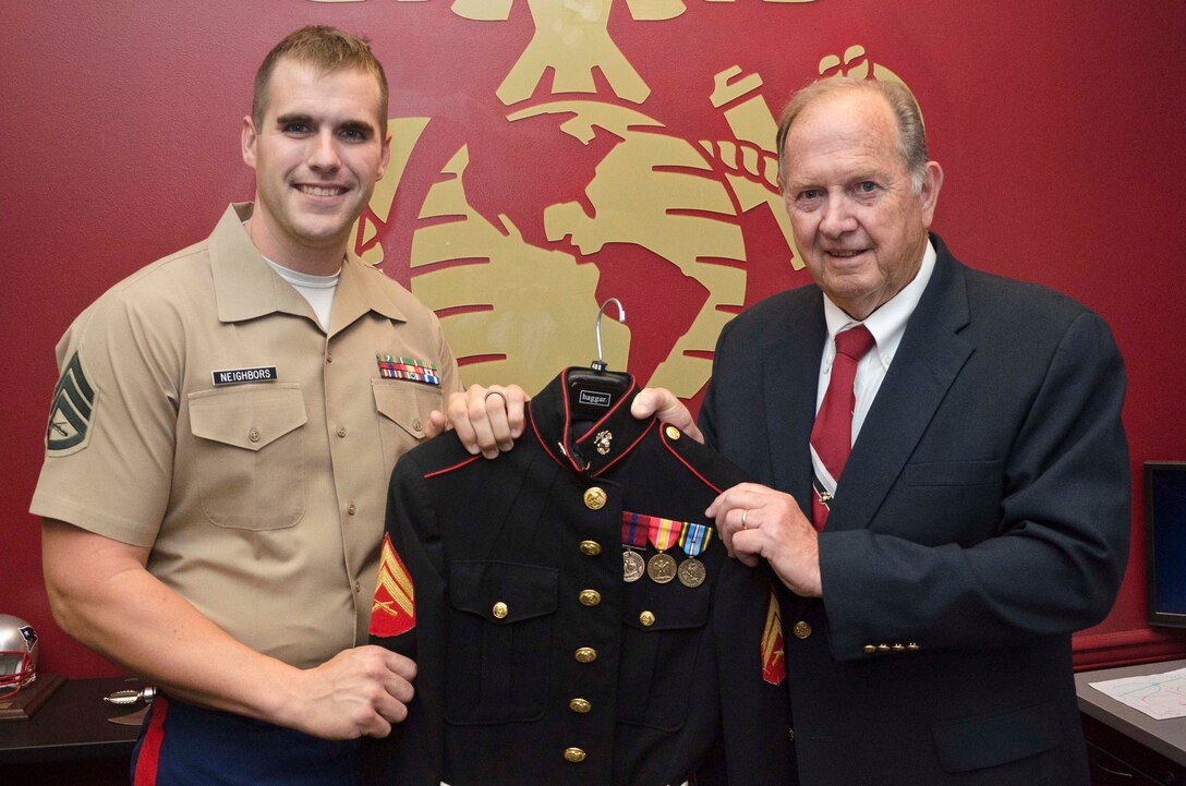 U.S. Marine Corps Staff Sgt. Max G. Neighbors, a canvassing recruiter with Recruiting Station Baltimore, poses with Robert L. Thomas and his dress blues jacket at Recruiting Sub-Station Salisbury, Md., July 21, 2014. The recruiters at RSS Salisbury were able to help Thomas arrange the medals correctly on his dress blues jacket. Thomas, a 73-year-old native of Cambridge, Md., served in the Marine Corps from 1959-63. (U.S. Marine Corps photo by Sgt Bryan J. Nygaard/Released)