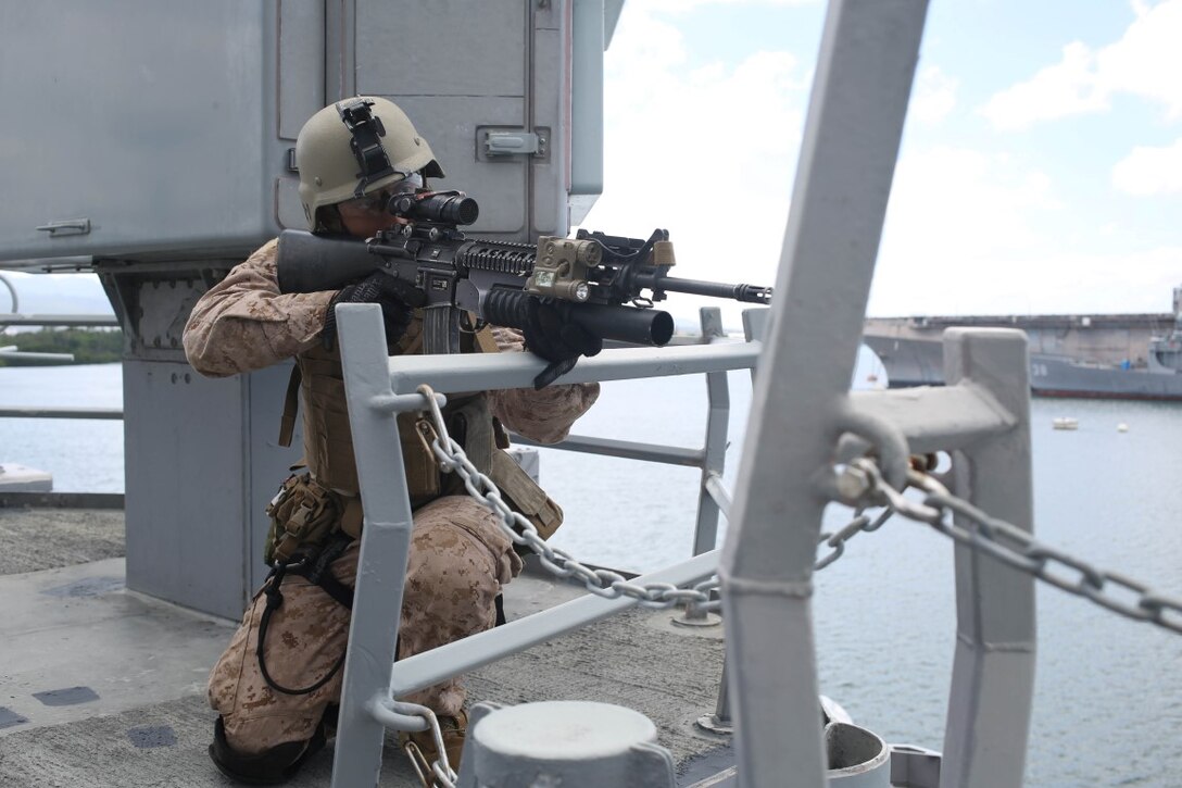 A Marine with the reconnaissance detachment, 11th Marine Expeditionary Unit, holds security on the Reuben James as part of a visit, board, search and seizure training exercise at Naval Base Pearl Harbor, Hawaii, July 28, 2014. The 11th MEU and Makin Island Amphibious Ready Group are deployed as a sea-based, expeditionary crisis response force capable of conducting amphibious missions across the full range of military operations. (U.S. Marine Corps photo by  Lance Cpl. Evan R. White/Released)