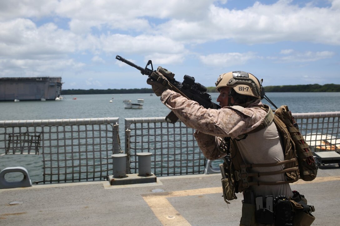 A Marine with the reconnaissance detachment, 11th Marine Expeditionary Unit, clears the Reuben James as part of a visit, board, search and seizure training exercise at Pearl Harbor, Hawaii, July 28, 2014. The 11th MEU and Makin Island Amphibious Ready Group are deployed as a sea-based, expeditionary crisis response force capable of conducting amphibious missions across the full range of military operations. (U.S. Marine Corps photo by  Lance Cpl. Evan R. White/Released)
