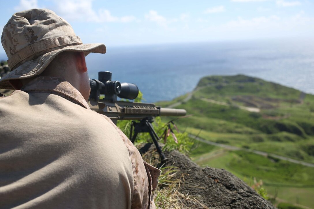 A Marine with Weapons Company, Battalion Landing Team 2nd Battalion, 1st Marines, 11th Marine Expeditionary Unit, executes a high angle sniper range during their WESTPAC deployment on Marine Corps Base Hawaii, July 31, 2014. The 11th MEU and Makin Island Amphibious Ready Group are deploying as a sea-based, expeditionary crisis response force capable of conducting amphibious missions across the full range of military operations. (U.S. Marine Corps photo by Lance Cpl. Evan R. White/Released)