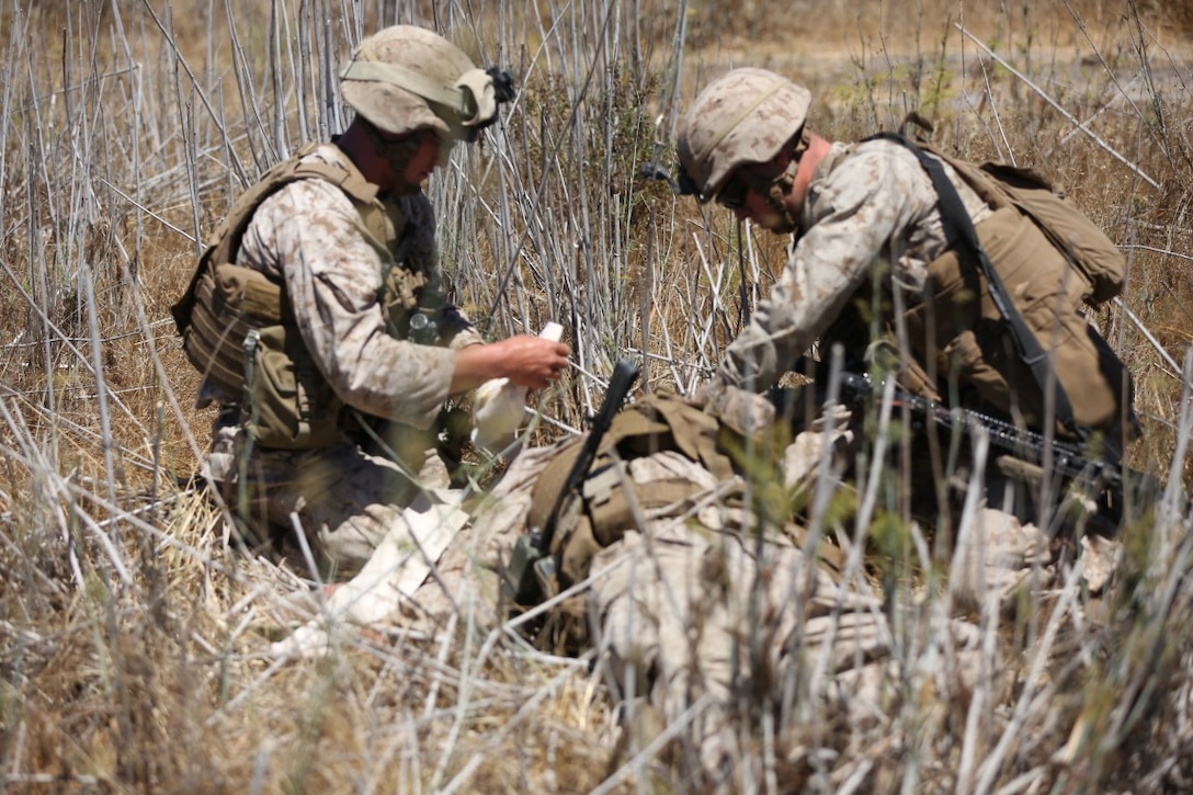 Marines with 1st Battalion, 4th Marine Regiment, 1st Marine Division, conduct notional field medical care during a Special Operations Training Group raid aboard Marine Corps Base Camp Pendleton, Calif., Aug. 5, 2014. Field medical care is an essential part of caring for injured Marines on the battlefield in a deployed environment.
