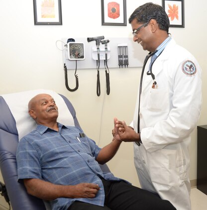 Dr. Udayakumar Kathaiyan, a primary care provider, (left) talks with Army veteran Walter Crawford Aug. 1 at the Veterans Administration community-based outpatient clinic now located aboard Marine Corps Logistics Base Albany.