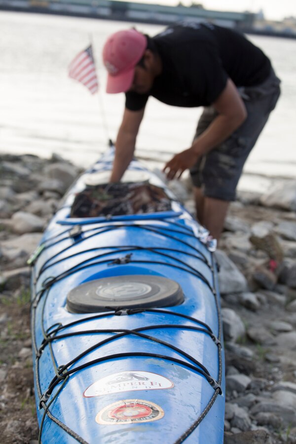 Nic Doucette and Gabe Vasquez, both retired Marines, kayak through the heart of New Orleans down the Mississippi River to honor the service of Sgt. Gabriel Martinez and Cpl. Justin Gaertner here, Aug. 6, 2014. Both Martinez and Gaertner stepped on pressure plate-activated improvised explosive devices while using their metal detectors in Afghanistan Nov. 26, 2010. Both Marines lost their legs but survived. New Orleans was the last major city Doucette and Vasquez passed through during their 2,552 mile journey from Lake Itasca, Minnesota to the Gulf of Mexico. (U.S. Marine Corps photo by Cpl. Codey Underwood)