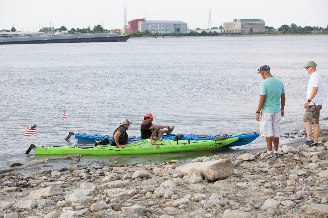 Nic Doucette and Gabe Vasquez, both retired Marines, arrive to the shore and greeted by Marines from Headquarters Battalion, Marine Forces Reserve, here Aug. 6 2014. The two Marines kayaked through the heart of New Orleans down the Mississippi River to honor the service of Sgt. Gabriel Martinez and Cpl. Justin Gaertner. Both Martinez and Gaertner stepped on pressure plate-activated improvised explosive devices while using their metal detectors in Afghanistan Nov. 26, 2010. Both Marines lost their legs but survived. New Orleans was the last major city Doucette and Vasquez passed through during their 2,552 mile journey from Lake Itasca, Minnesota to the Gulf of Mexico. (U.S. Marine Corps photo by Cpl. Codey Underwood)