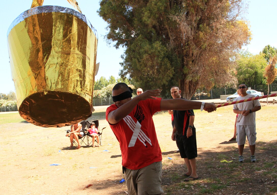 Marines of Recruiting Station San Francisco took turns swinging at a piñata aboard NASA Moffett Airfield in Mountain View, Calif. during the RS' Family Day, August 1, 2014. Family and friends joined the Marines to enjoy a well earned day off from their high operational tempo, after all 14 Recruiting Sub-Stations accomplished their mission in July.