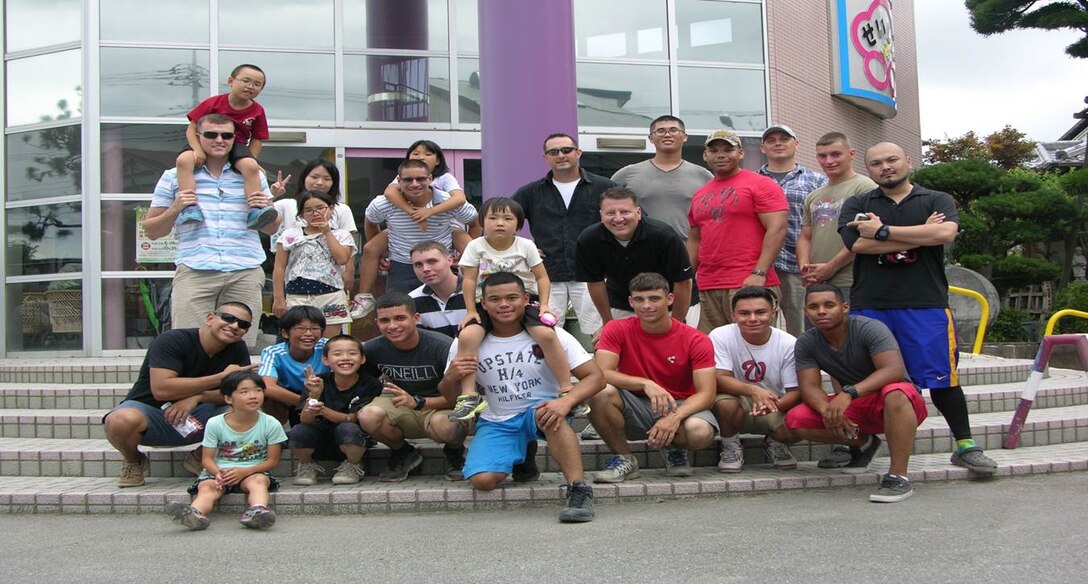 Community relation group photo taken with Camp Fuji’s Marines and the children of Seishin Children’s Home in Japan on 23 August 2014. 
