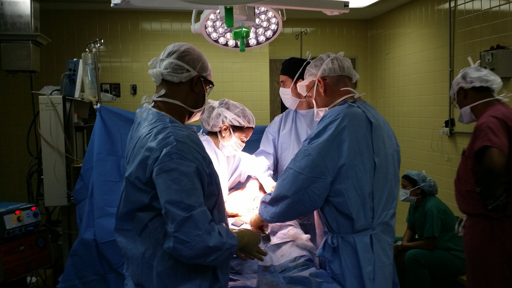 General surgery residents from Hospital Escuela and the surgeon from Joint Task Force-Bravo's Medical Element Mobile Surgical Team (MST) perform a surgical procedure during a Medical Readiness Training Exercise (MEDRETE) in Tegucigalpa, Honduras, July 29-31, 2014. The MST evaluated patients in the emergency department, developed an operating plan, carried out the surgery, and recovered patients all while teaching Honduran surgical residents the process step by step.  (Courtesy Photo)