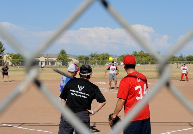 A member of the 13th Intelligence Squadron attempts to hit a softball at the 2014 Intramural Softball Championships at O’Malley Field on Beale Air Force Base, Calif., July 31, 2014. 9th Munitions defeated 13th IS, 19-4. (U.S. Air Force photo by Staff Sgt. Robert M. Trujillo/Released)